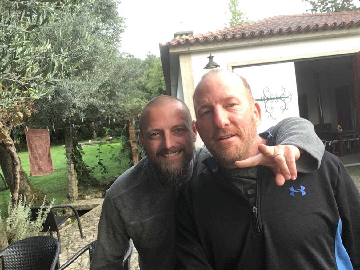 Two pilgrims smiling in a garden in the evening