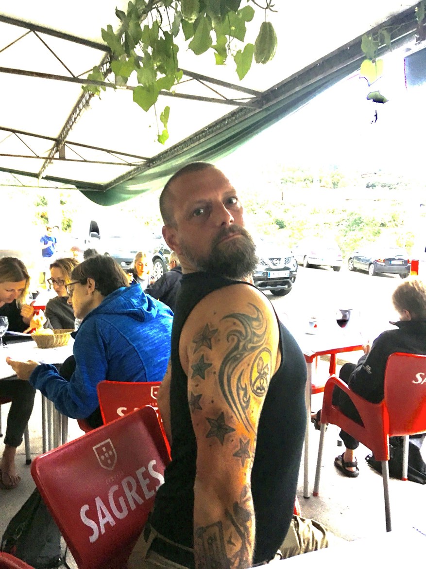 A pilgrim relaxing at a café with a Sagres beer