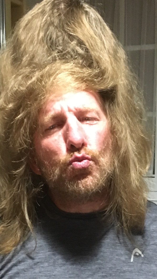 A pilgrim wearing a long blonde wig