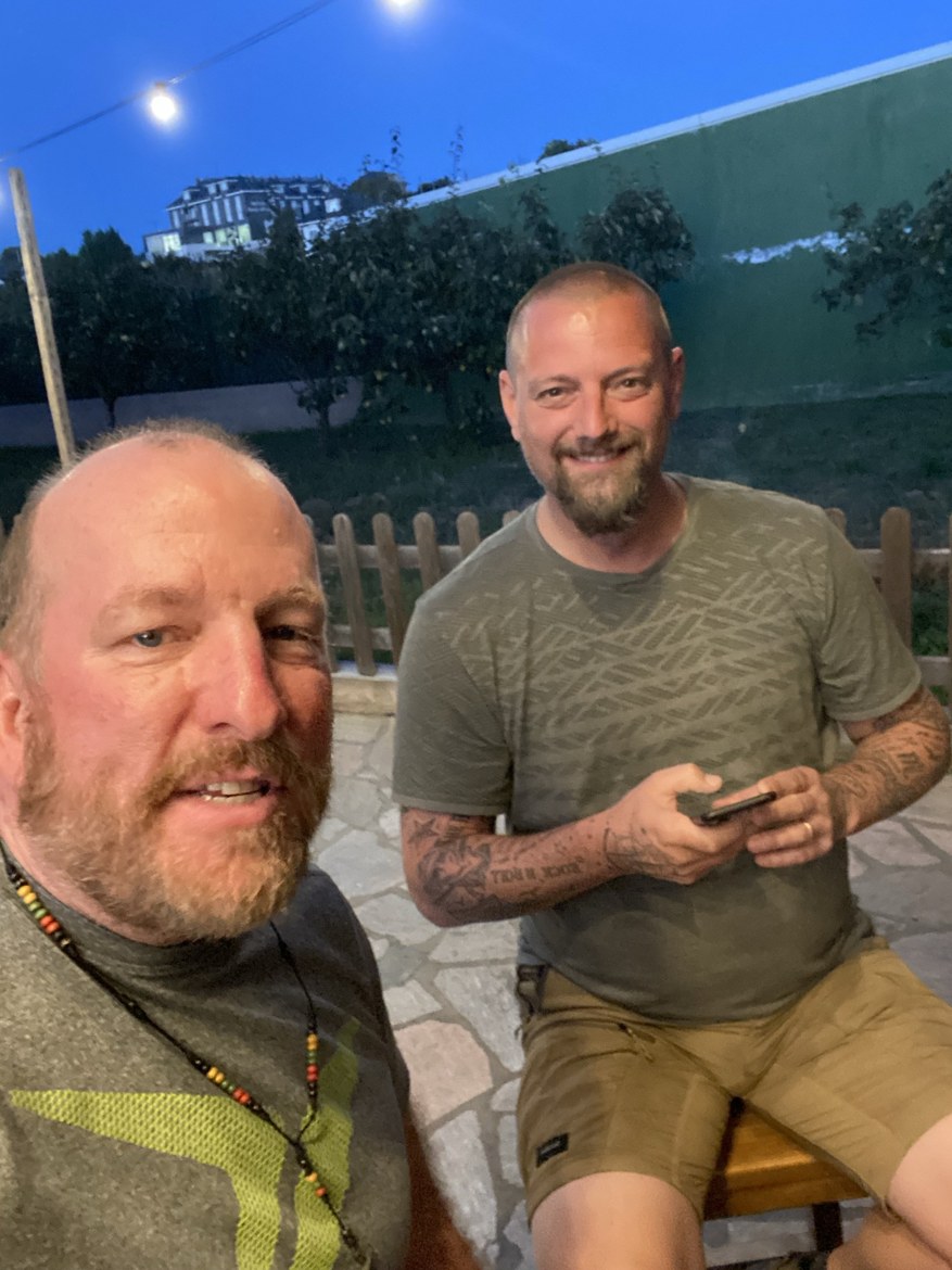 Two pilgrims relaxing on a terrace at dusk