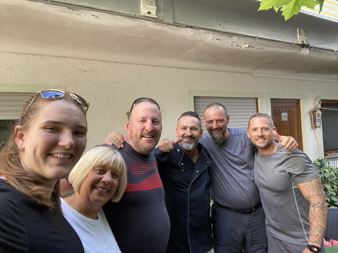 A group of six standing outside a house before the walk