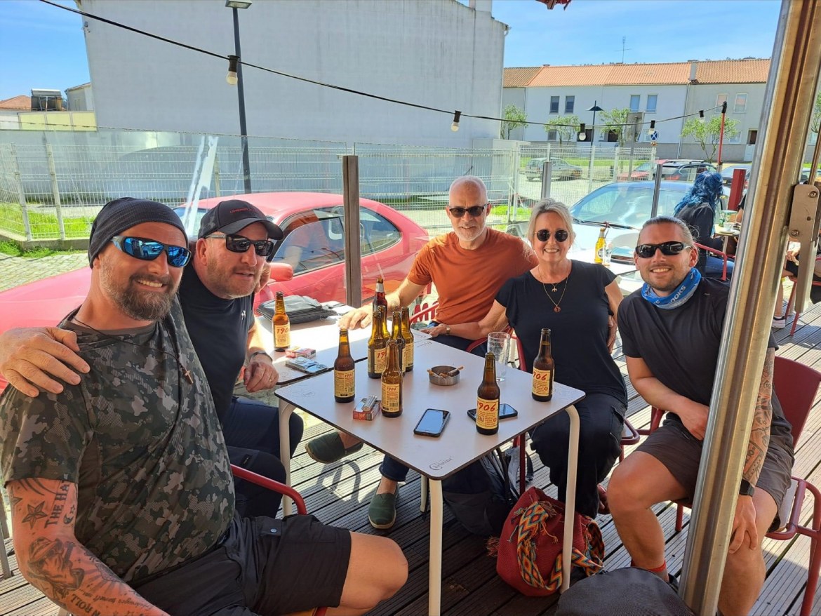 The three brothers with two fellow pilgrims around a terrace table with beers