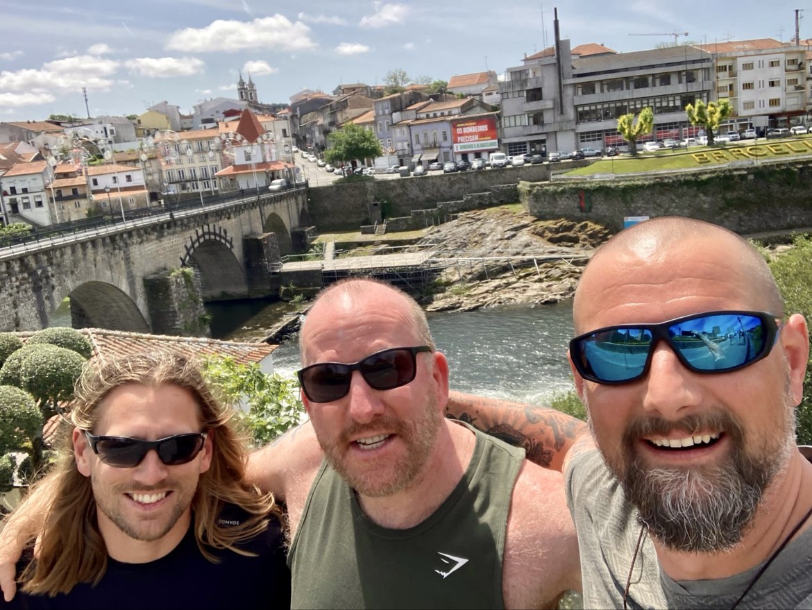 Mike, Nicki and Dennis taking a selfie on the bridge at Barcelos, the river behind them