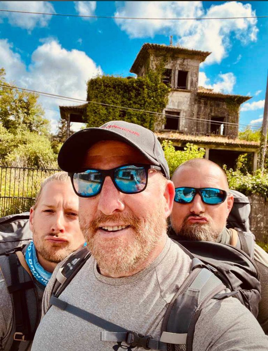 Mike, Nicki and Dennis in front of a ruined, ivy-covered villa