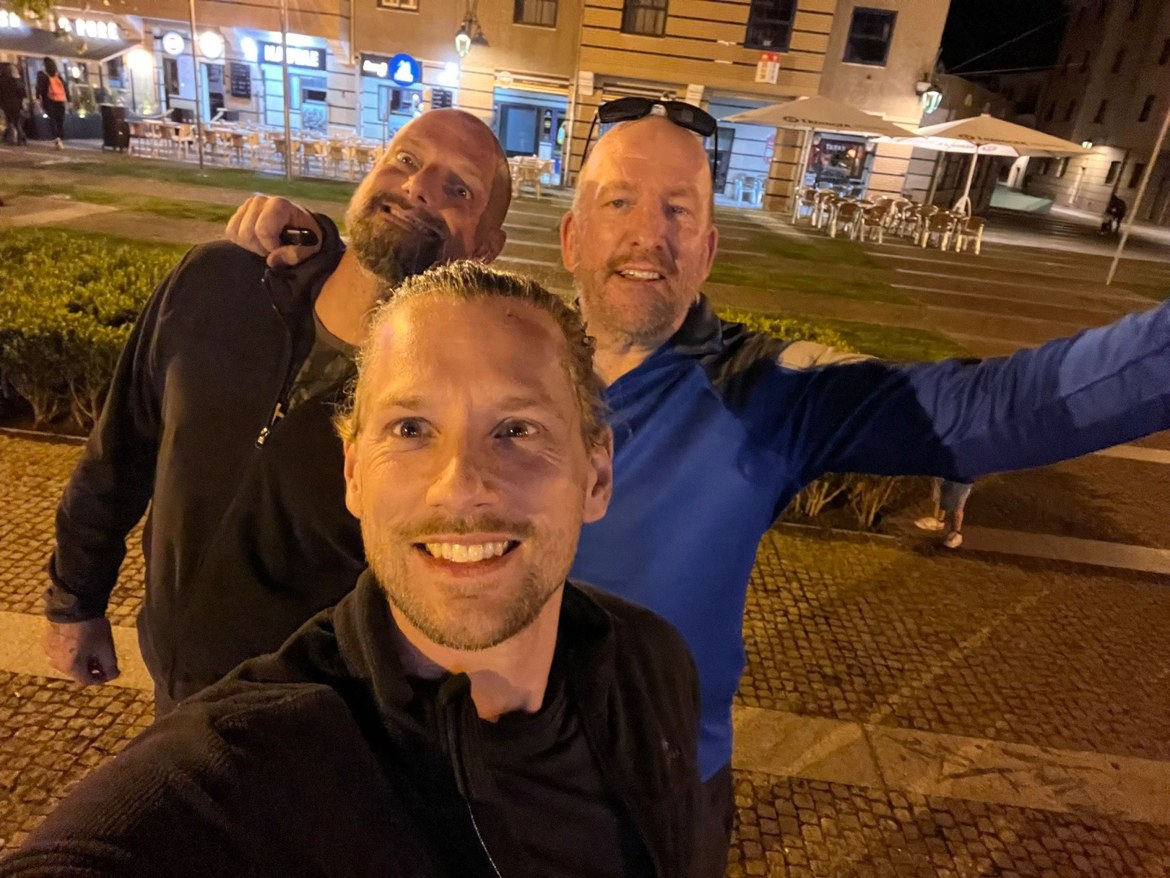 Nicki and Mike taking a selfie in a plaza at night