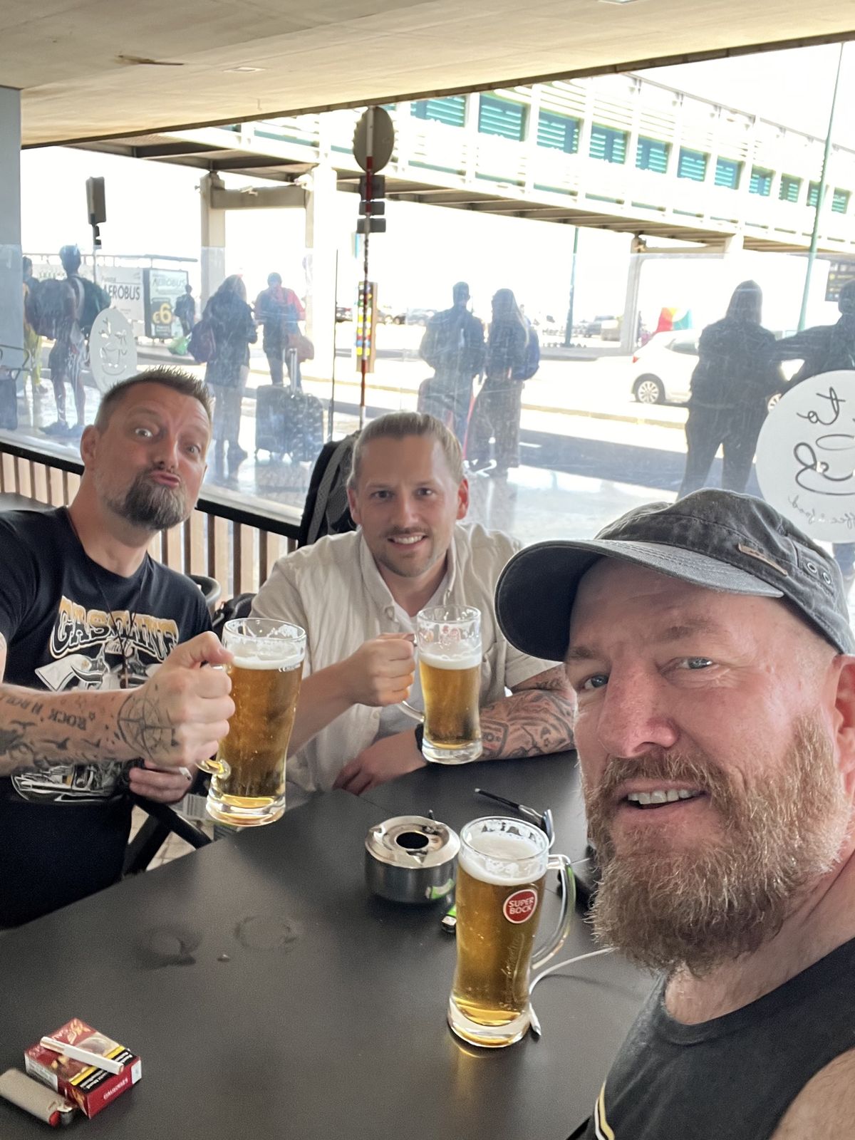 The three Camino Brothers raising beer mugs at Funchal airport