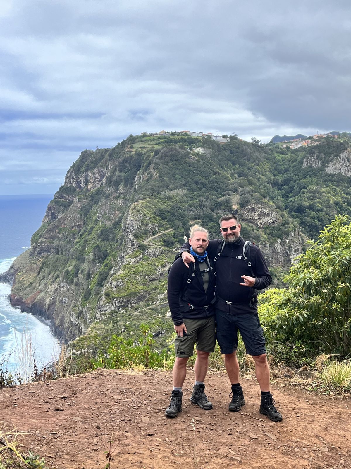 Two of the brothers standing on a cliff path above the ocean