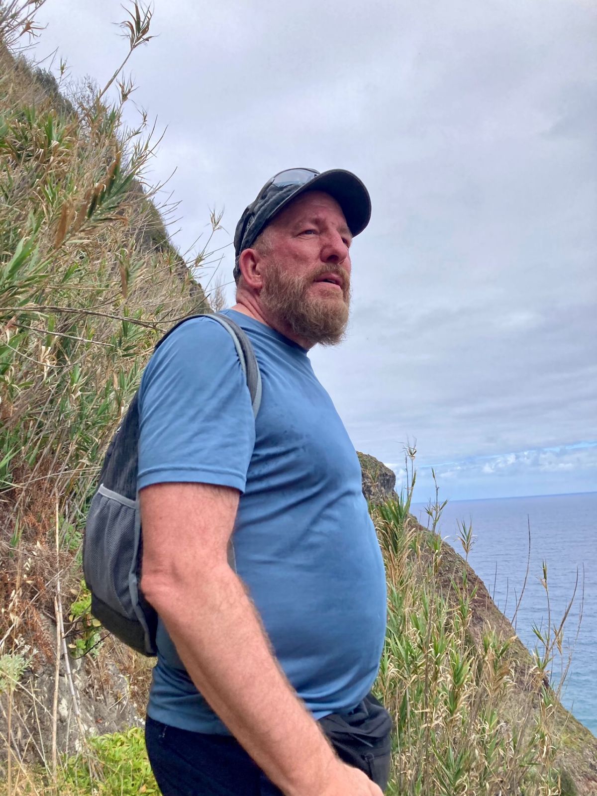 Mike in profile on a coastal path with the Atlantic behind him