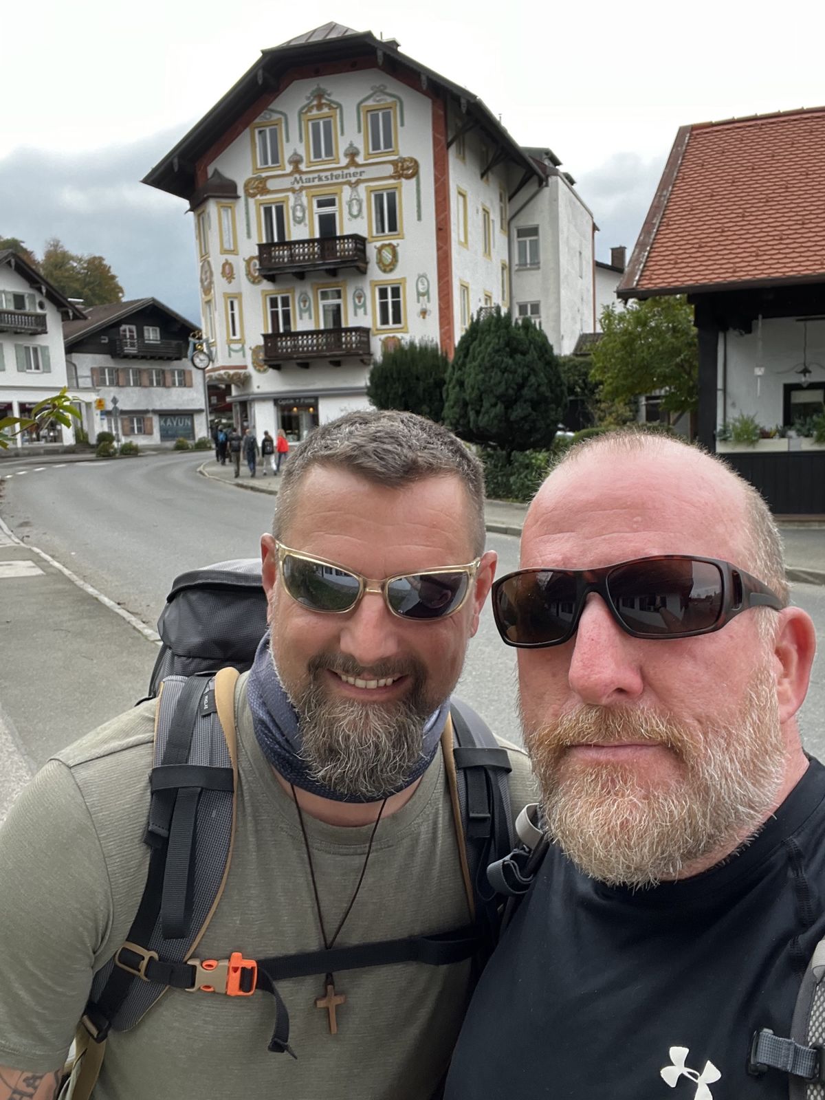 Mike and Nicki in a Bavarian village in front of a house with painted facade