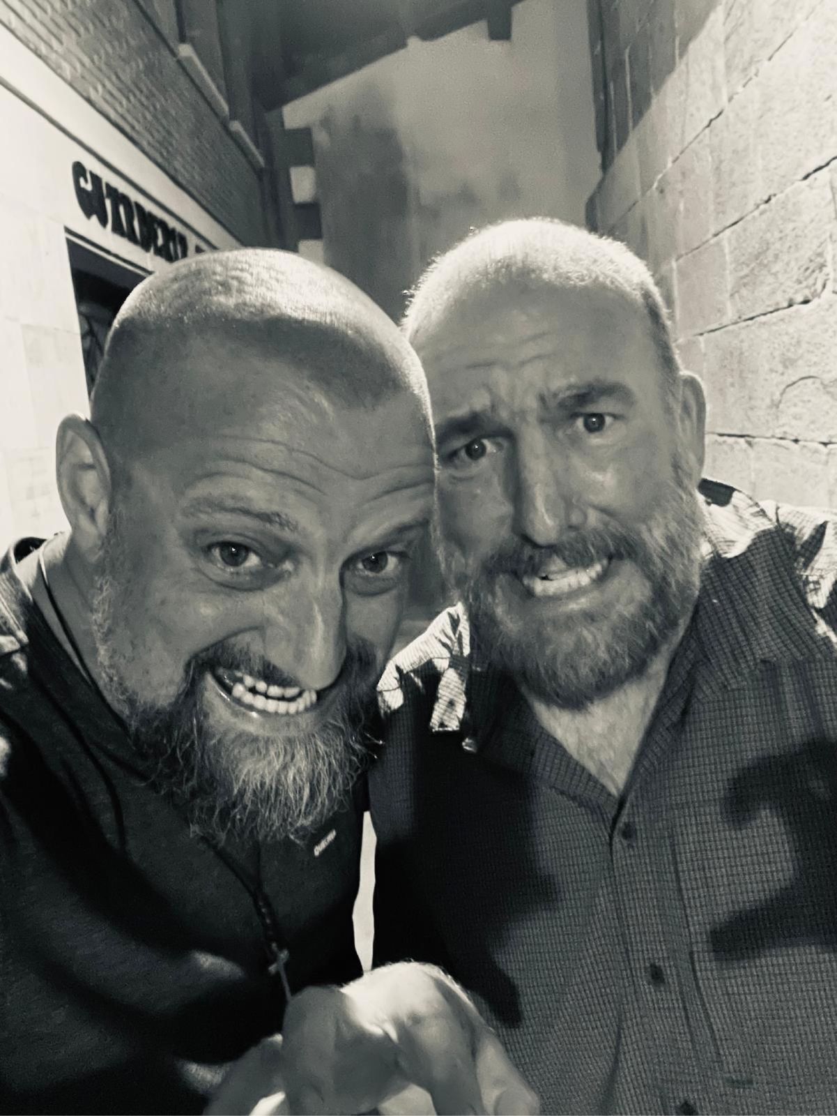 Black-and-white selfie of Nicki and Mike grinning in a narrow alley at night