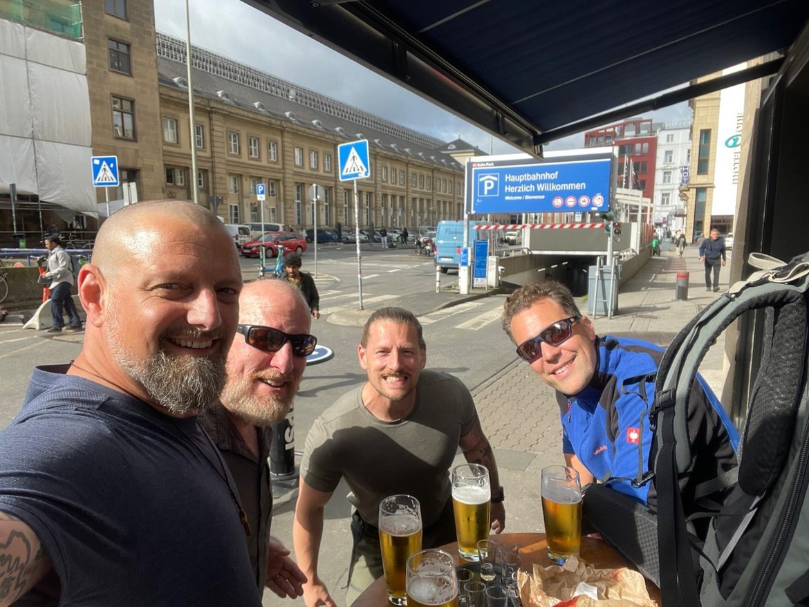 Nicki, Mike and Dennis with a friend, beers on the table outside the Hauptbahnhof