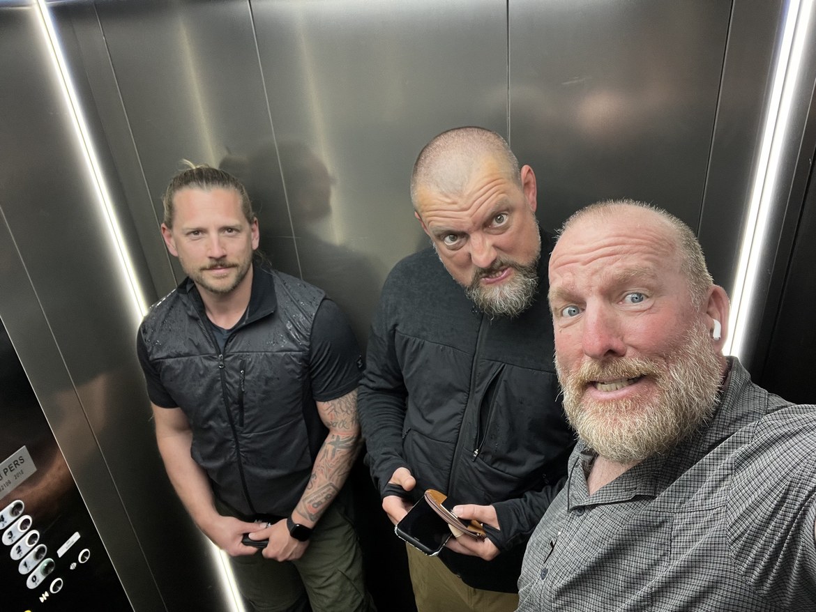 Dennis, Nicki and Mike posing together in an elevator